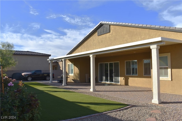 rear view of property featuring a patio area