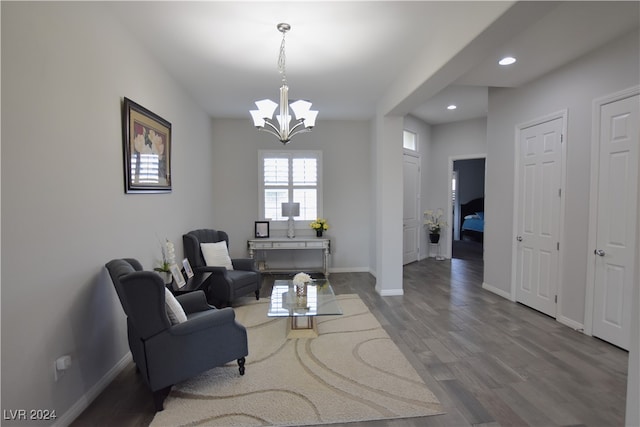 living room with hardwood / wood-style floors and a notable chandelier