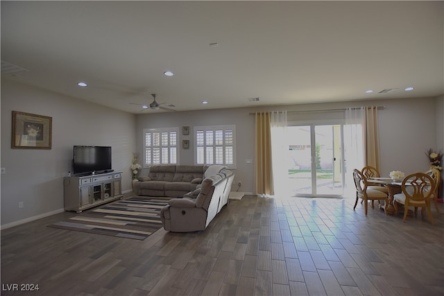 living room featuring a wealth of natural light and dark hardwood / wood-style flooring