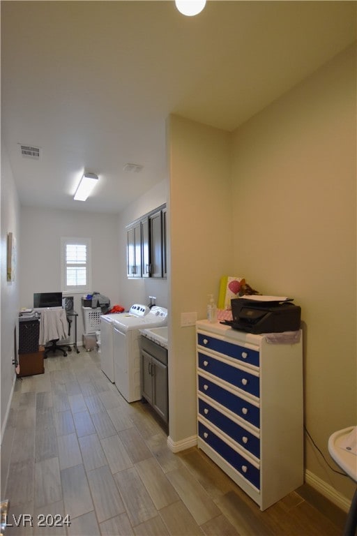 laundry room with cabinets and separate washer and dryer