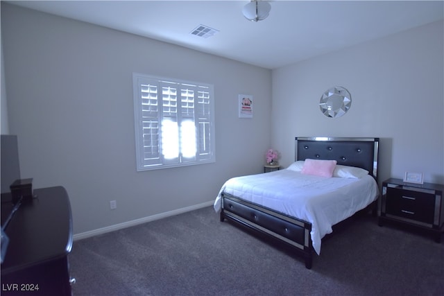 bedroom featuring dark carpet