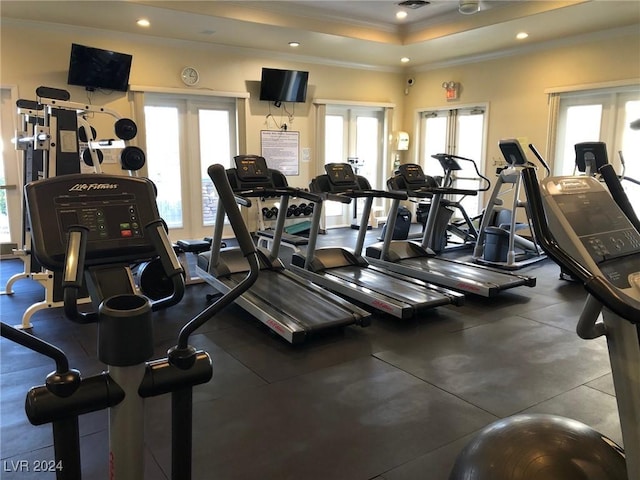 exercise room featuring french doors, crown molding, and a raised ceiling