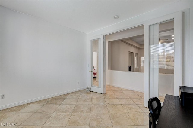 empty room with light tile patterned flooring and ceiling fan