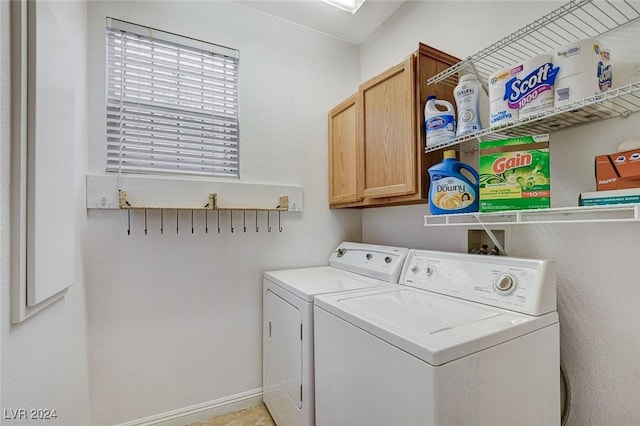 laundry room featuring cabinets and washer and dryer