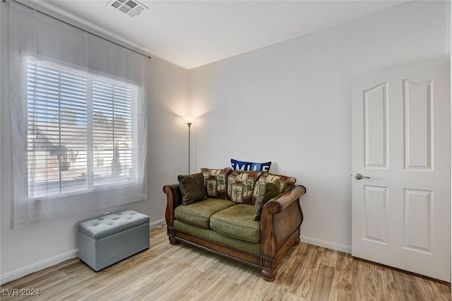 living area with hardwood / wood-style flooring