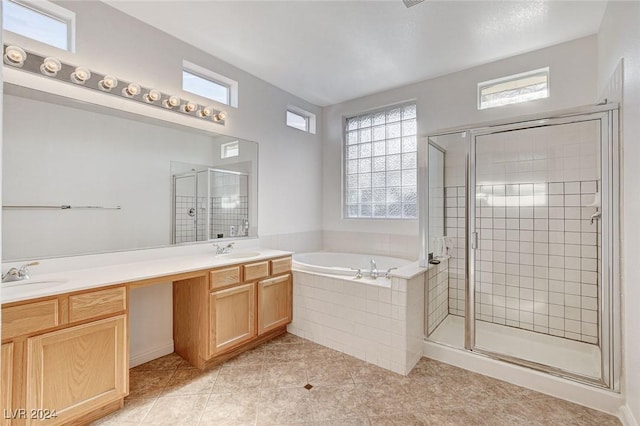 bathroom with tile patterned flooring, shower with separate bathtub, and vanity