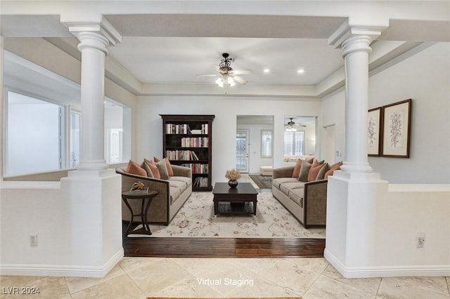 living room featuring ceiling fan and ornate columns