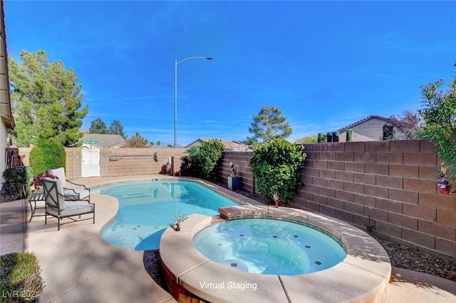 view of pool featuring an in ground hot tub