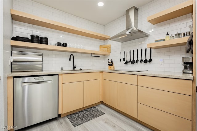 kitchen with dishwasher, light hardwood / wood-style flooring, wall chimney exhaust hood, and sink