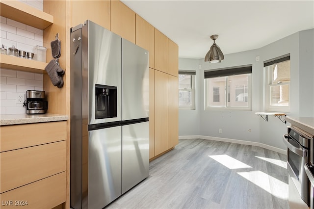 kitchen with tasteful backsplash, hanging light fixtures, light hardwood / wood-style floors, and stainless steel refrigerator with ice dispenser