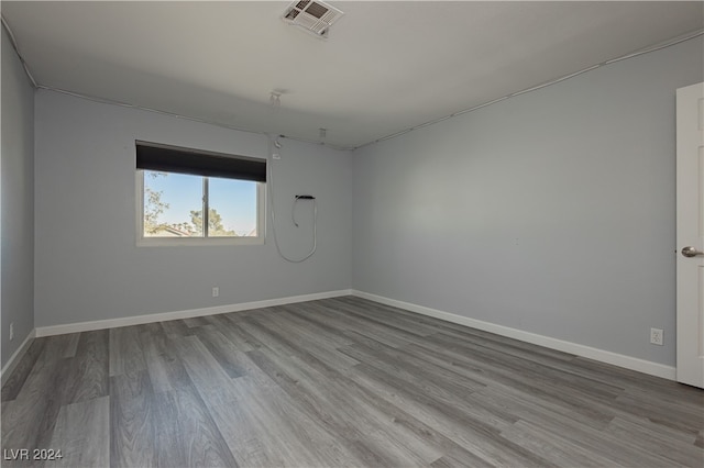 spare room featuring wood-type flooring