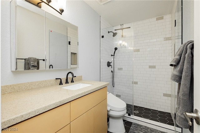 bathroom with tile patterned flooring, vanity, toilet, and walk in shower