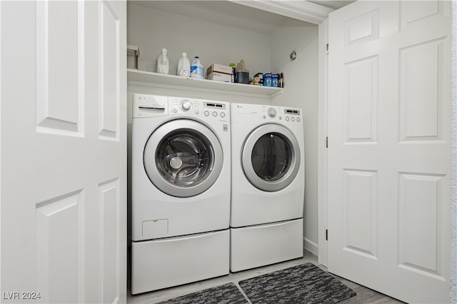 laundry room with hardwood / wood-style flooring and washing machine and dryer