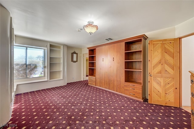 interior space with dark colored carpet