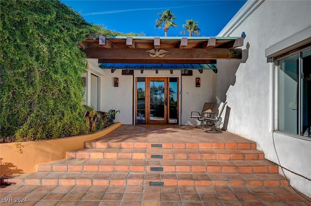 doorway to property with a patio