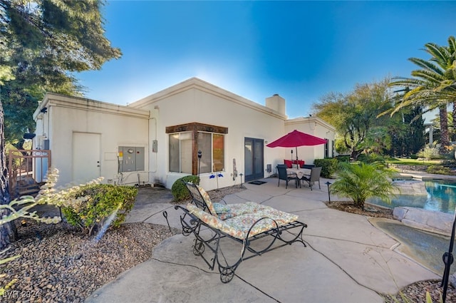 rear view of property featuring a patio area