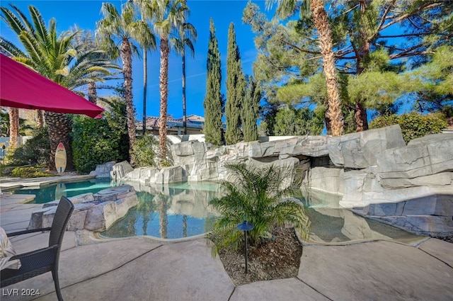 exterior space with a swimming pool with hot tub