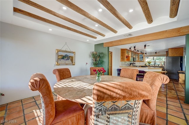 dining room with beamed ceiling and light tile patterned flooring