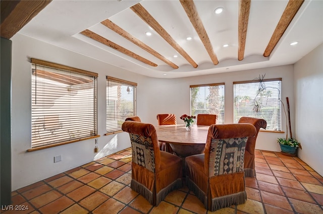 dining room with beam ceiling and tile patterned floors