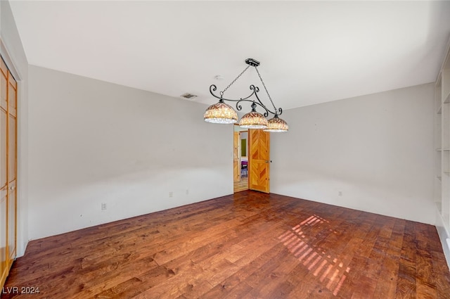 unfurnished dining area featuring wood-type flooring