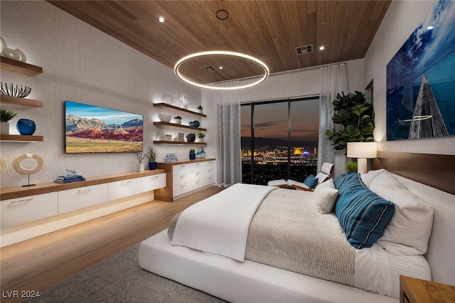 bedroom with light hardwood / wood-style flooring and wood ceiling