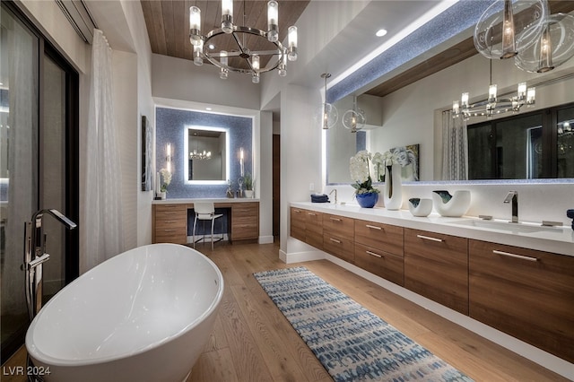 bathroom featuring hardwood / wood-style floors, vanity, and a tub