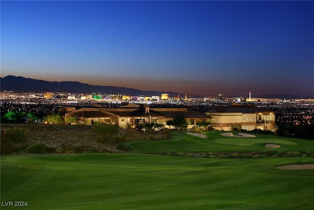 surrounding community with a mountain view and a yard