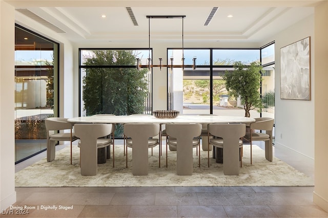 unfurnished dining area with a raised ceiling and a wealth of natural light