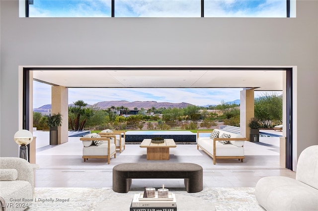 interior space with a mountain view, light hardwood / wood-style floors, and a high ceiling