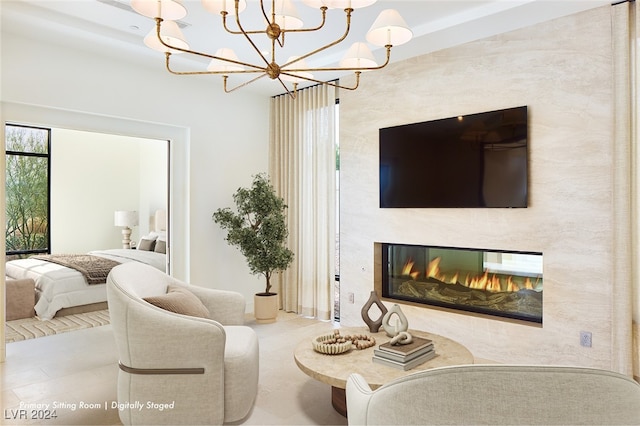 tiled living room with a chandelier and a large fireplace