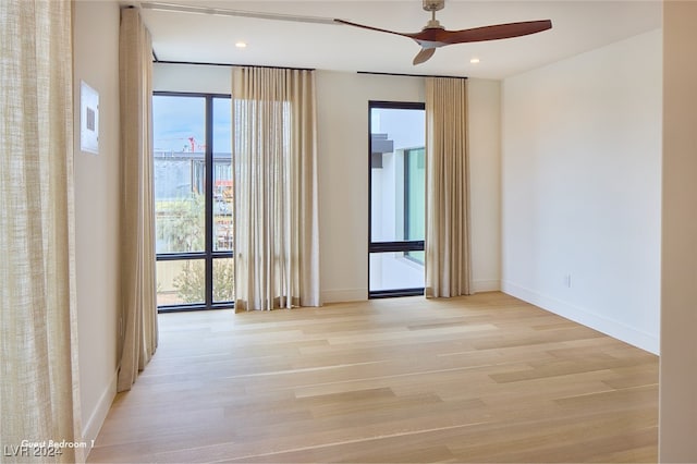 unfurnished room with light hardwood / wood-style flooring and ceiling fan