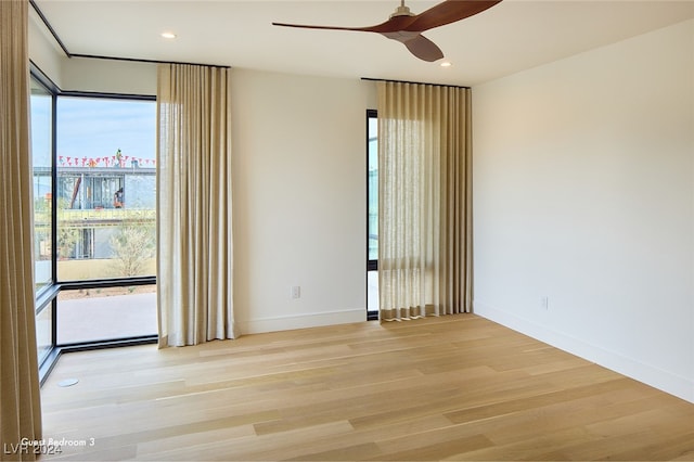 spare room with ceiling fan and light hardwood / wood-style flooring