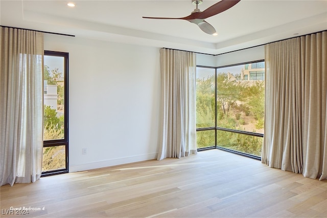 spare room with light hardwood / wood-style floors and ceiling fan