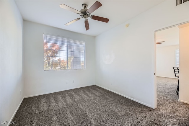 carpeted spare room with ceiling fan