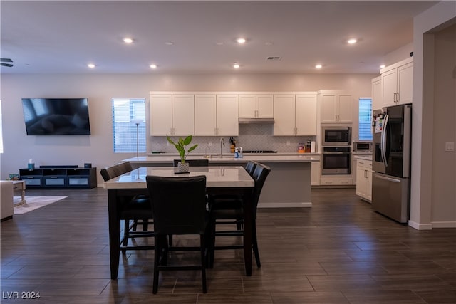 dining space featuring dark wood-type flooring and sink