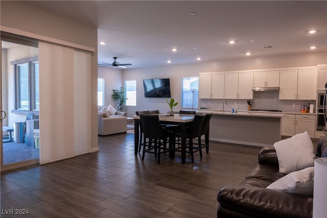 dining room featuring dark hardwood / wood-style floors, ceiling fan, and sink