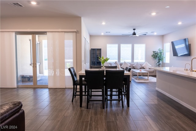 dining space with ceiling fan and dark hardwood / wood-style flooring