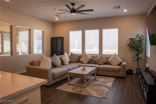 living room with ceiling fan and dark wood-type flooring