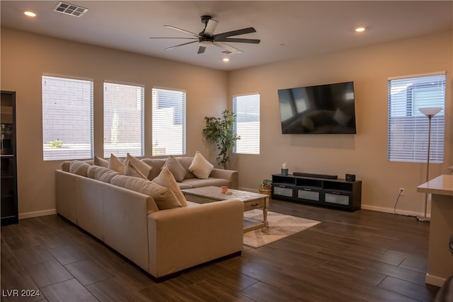 living room featuring dark hardwood / wood-style floors and ceiling fan