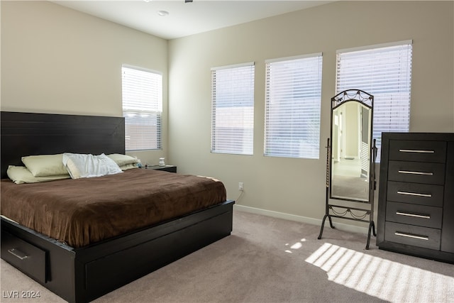 carpeted bedroom featuring multiple windows