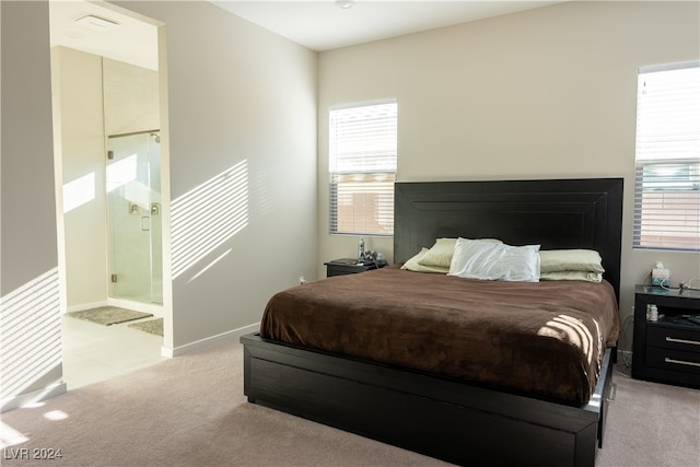 carpeted bedroom featuring ensuite bathroom