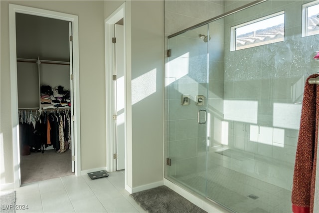 bathroom with tile patterned floors and a shower with shower door