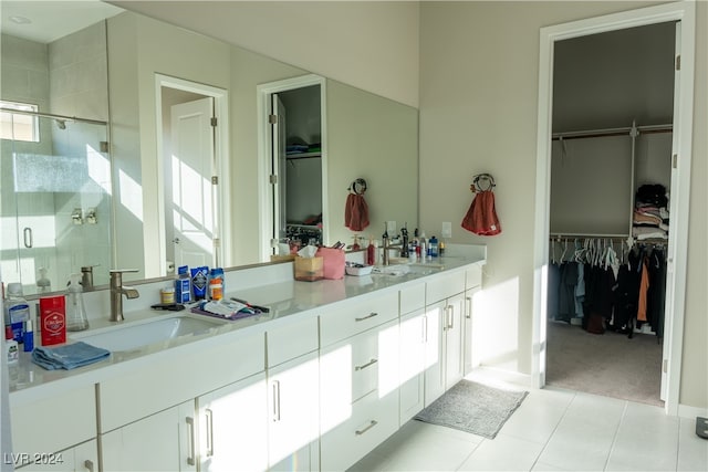 bathroom with tile patterned flooring, vanity, and an enclosed shower