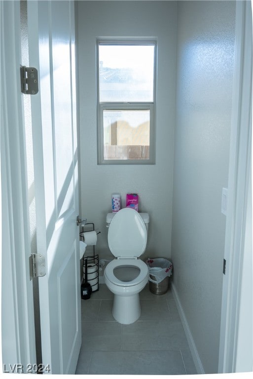 bathroom with tile patterned flooring and toilet