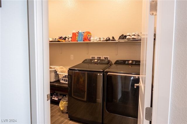 laundry room featuring hardwood / wood-style flooring and washer and clothes dryer