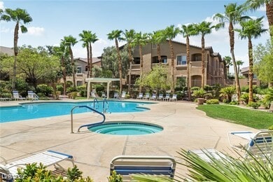 view of pool with a patio and a hot tub