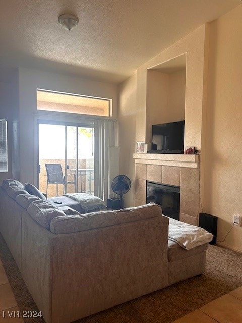 tiled living room with a fireplace and a textured ceiling