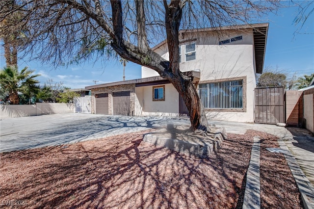 rear view of property with a garage