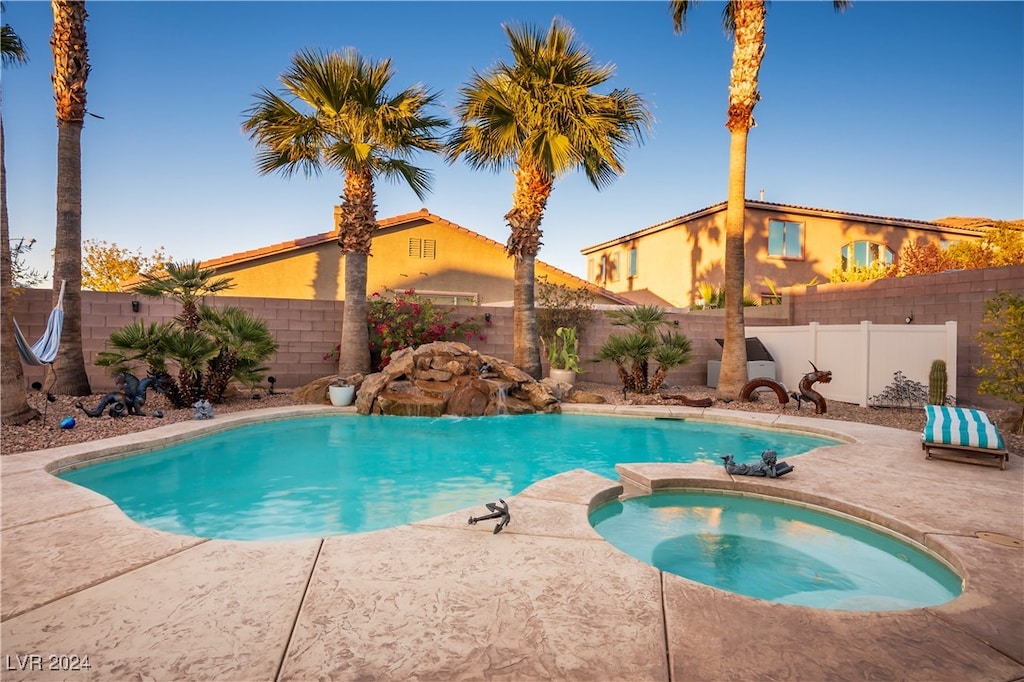 view of swimming pool featuring an in ground hot tub