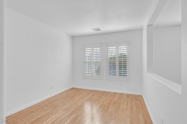 unfurnished room with light hardwood / wood-style floors